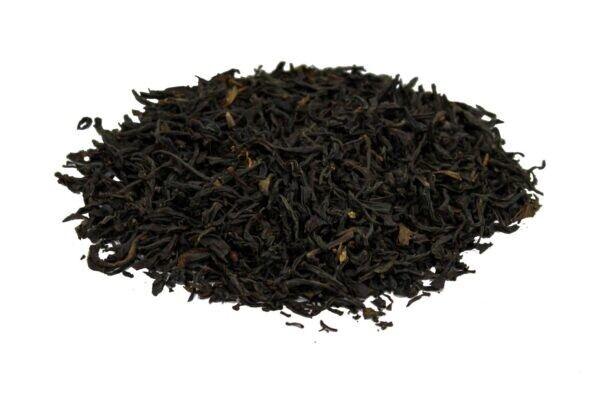 Pile of loose green black tea leaves isolated on white background