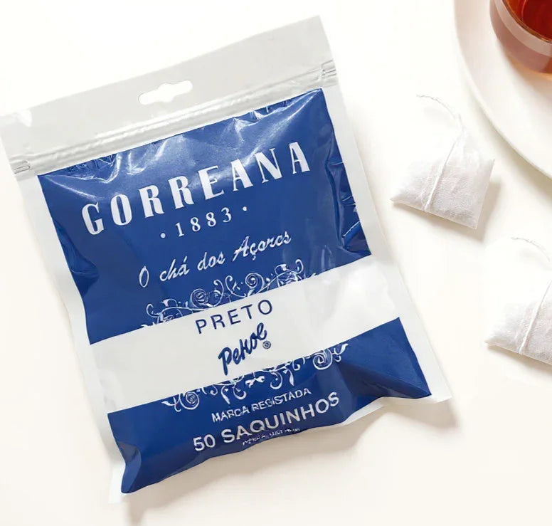 Gorreana black tea bag package with two tea bags and a cup of tea on white background